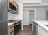 Sleek modern kitchen with stainless steel appliances, elegant wooden cabinetry, and a pristine marble countertop island.