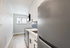 Bright and modern kitchen featuring sleek countertops, stainless steel appliances, and white cabinetry, exuding contemporary elegance.