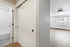 Bright, modern apartment showcasing an elegant entryway, sleek closet doors, and a spacious living area with ample natural light.