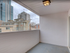 Charming private balcony with modern lighting, offering urban views in a vibrant cityscape.
