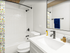 Bright and modern bathroom with sleek fixtures, a large mirror, and a chic shower curtain for a refreshing feel.