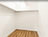 Spacious walk-in closet with elegant wooden flooring and ample hanging space, perfect for stylish storage solutions.
