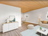 Inviting living space with modern decor, featuring wooden ceiling, cozy seating area, and stylish furniture, perfect for a warm and welcoming atmosphere.