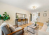 Bright and inviting living area featuring elegant decor, modern lighting, and warm wooden flooring, offering a cozy yet sophisticated ambiance.