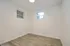 Bright and inviting room with elegant hardwood flooring and two windows, perfect for a cozy bedroom or functional office space.
