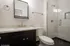 Contemporary bathroom featuring a sleek vanity with modern fixtures, glass-enclosed shower, and stylish tile flooring.