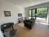 Bright, modern living room with large windows, cozy seating, and elegant decor, perfect for relaxation and entertaining.