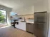 Modern kitchen with sleek white cabinetry, stainless steel appliances, and ample natural light, offering a perfect blend of style and functionality.