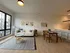 Chic and modern living space featuring a cozy sofa, elegant coffee table, and a stylish dining area with natural light flooding in through large windows.