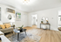 Chic and airy living room with stylish decor, featuring a plush sofa, modern coffee table, and charming wall accents.