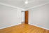 Bright and airy room with sleek gray walls and elegant hardwood flooring, perfect for a modern living space.