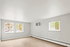 Bright, airy room with large windows and elegant light wood flooring, perfect for modern living.