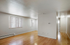 Bright and inviting living space with sleek hardwood floors, modern recessed lighting, and ample natural light from large windows.