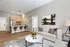 Chic open-plan living space with modern kitchen, elegant bar seating, and stylish decor.
