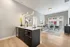 Modern apartment interior featuring a sleek kitchen with island, bright living room with large window, and stylish decor elements.