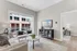 Bright and modern living room with chic decor, large window, and a cozy ambiance, perfect for city living.