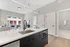 Modern apartment interior showcasing a sleek kitchen with elegant marble countertops, open living room with large windows, and stylish decor for a luxurious feel.