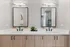 Elegant bathroom vanity with dual sinks, sleek black faucets, modern lighting, and stylish wood cabinets.