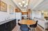 Modern apartment interior featuring a cozy living room with elegant chandelier, stylish dining area, and compact kitchen with wooden cabinets.