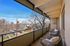 Inviting balcony view showcasing a serene neighborhood setting with cozy seating, perfect for relaxation and enjoying the outdoors.