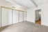 Bright and spacious bedroom with plush carpeting, ample closet space, and direct access to a sleek bathroom.