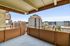 Expansive city view from a modern apartment balcony with sleek railing design.