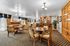 Elegant dining room with plush seating, polished wood furniture, and a classic bar setup exudes timeless sophistication and comfort.