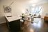 Modern open-concept living space featuring a sleek kitchen island, cozy dining area, and bright living room with large windows and elegant decor.