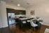 Old Town Chicago, IL, Apartments Near Lincoln Park - 1537 N Orleans - A Modern Open-Concept Kitchen With Dark Wood Cabinets, Stainless Steel Appliances, And A White Island With Bar Stools.