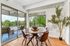 Speer, CO, Apartments Near Cherry Creek Trail - El Greco Apartments - Dining Area With Round Table, Modern Chairs, Indoor Plant, Sliding Glass Doors to Covered Balcony, and Tree-Filled Views.