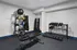 Modern home gym with dumbbells, kettlebells, exercise balls, and a sleek bench for a comprehensive workout experience.
