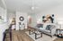 Modern living room with stylish decor, comfortable gray sofa, chic coffee table, and contemporary artwork on the wall.