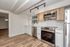 Modern kitchen with sleek stainless steel appliances, elegant track lighting, and stylish wood flooring, perfect for contemporary living.