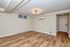 Inviting apartment space showcasing elegant wood flooring, modern lighting fixture, and a sleek wall-mounted air conditioning unit.