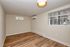 Bright, airy room with sleek wood flooring, a large window offering natural light, and modern air conditioning unit for comfort.
