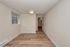 Inviting room with elegant wood flooring and soft, neutral walls, perfect for personalizing your space and enjoying natural light.