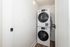 Modern laundry space featuring a sleek stacked washer and dryer unit tucked into a bright, compact area.