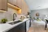 Modern open-concept kitchen and living area with sleek cabinetry, elegant tile backsplash, and cozy lounge seating.