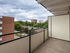 Inviting balcony with scenic urban view, perfect for relaxation and outdoor dining.