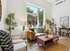 Bright and cozy living room featuring a stylish sofa, modern decor, and large windows with scenic views.