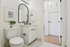 Chic bathroom with elegant black accents, modern vanity, and contemporary artwork, offering a serene and inviting atmosphere.