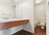 Modern bathroom featuring sleek double sinks, elegant fixtures, and a pristine bathtub in a stylish setting.
