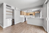 Bright, modern kitchen with sleek stainless steel appliances, elegant wooden cabinetry, and spacious open layout on wood flooring.