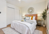 Inviting bedroom with plush bedding, soft lighting, and modern decor accents.