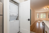 Bright apartment interior featuring an in-unit washer and dryer, hardwood floors, and large windows for natural light.