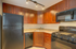Charming kitchen with rich wooden cabinets, sleek black appliances, and elegant granite countertops.