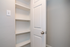Sleek built-in shelving unit with a modern white door, perfect for maximizing storage space.