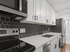 Modern kitchen with sleek black hexagonal backsplash, white cabinetry, and stainless steel appliances.