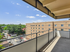 Bright and spacious balcony view showcasing a stylish urban landscape and clear blue skies.