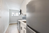 Bright and modern kitchen with sleek white cabinets, stainless steel appliances, and a stylish tiled backsplash.